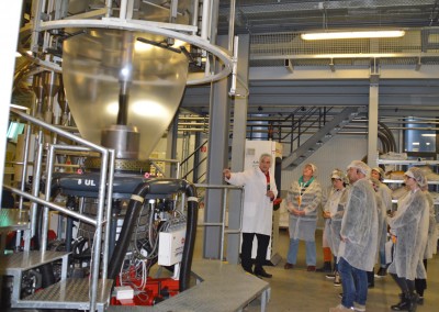 Mitarbeiter der Frischmann Kunststoffe GmbH mit Besuchern der Industrie InTouch beim Erklären einer Produktionsanlage