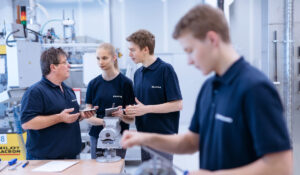 Teammitglieder der Röchling Medical Solutions SE, einem teilnehmenden Unternehmen bei der INDUSTRIE INTOUCH 2022, besprechen ein Werkstück an einer Werkbank.